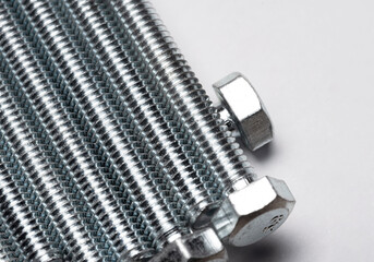 Bolts stacked side by side isolated on a white background. Screw thread creating structure and...