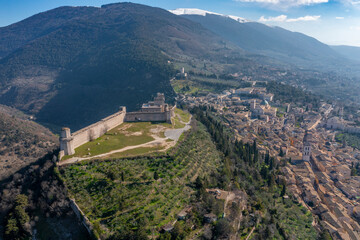 aerial view of the city of assisi umbria with snow covered mount subasio
