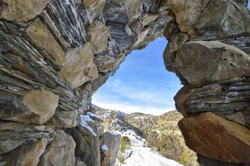View of the Pamir Mountains through a stone arch 