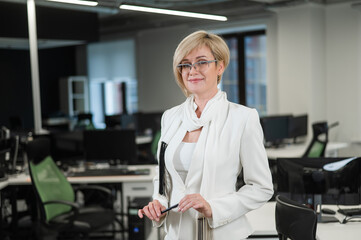 Portrait caucasian business woman shows holding a pen in the office.