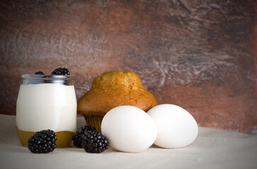 Nature Yogurt in Glass Jar with Carrot Muffin and Blackberries