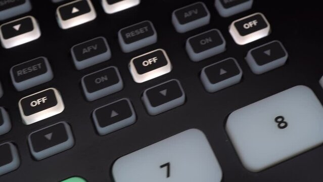 Professional digital mixer close-up. Camera control panel with many macro buttons. The camera makes a slide.