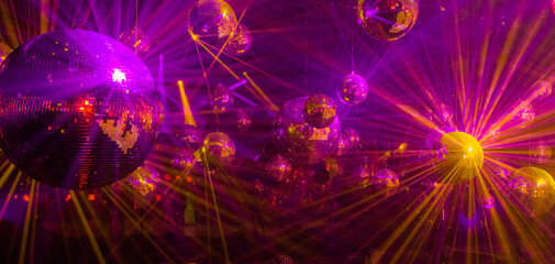 disco background with disco balls in purple and gold lighting