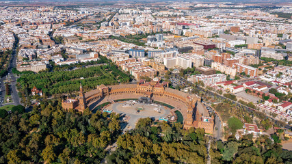 Fototapeta premium Aerial view of Spanish city of Seville in Andalusia region on river Guadaquivir overlooking Plaza de Espana and Parque Maria Luisa sunny day