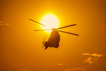  Helicopter in front of the sun at sunset © Catalin