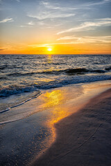 Colorful vertical sunset seascape and sun horizon in Gulf of Mexico sea ocean coast with water...