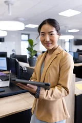 Keuken foto achterwand Aziatische plekken Vertical image of happy asian businesswoman looking at camera in office