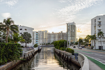 South Beach, Miami in evening sunset with condo apartment buildings in Florida with tropical palm...