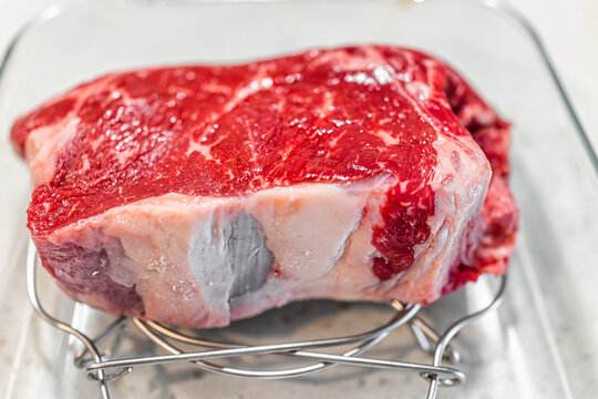 Macro Closeup Of New York Boneless Strip Steak Beef Thick Cut Meat In Glass Pan For Roasting Before Grilling With Juicy Texture