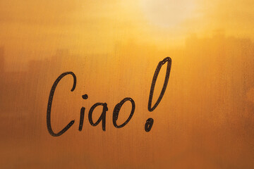 lettering Ciao in Italian language is bye in english on foggy glass on sunset window © ksenija1803z