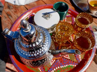 Aerial view of tea pot with glasses on colorful tray, Ourika valley, High Atlas Mountains, Morocco.