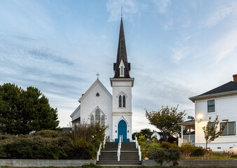 Front view of the Mendocino Presbyterian Church during sunrise. There are no people nearby