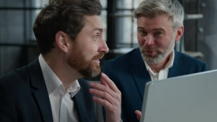 Close-up two surprised caucasian men different ages businessmen colleagues look in surprise at computer screen amazed corporate employees business partners receive good news win satisfied achievement