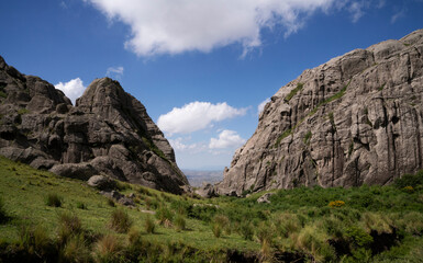 Fototapeta na wymiar Alpine landscape. Panoramic view of the rocky hills, valley and grassland. 