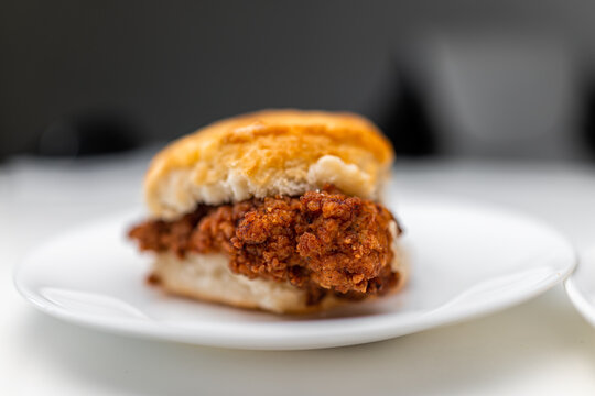 Chicken sandwich deep fried crispy meat on breakfast biscuit buns bread, fresh fast food on one white background kitchen table plate macro closeup