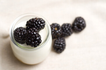 Macro Top View Image of Nature Yogurt in Glass Jar with Blackberries