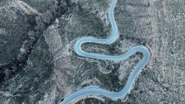 Aerial Drone view of dry valley and mountains at Gorafe, Desierto de los Coloraos in Blue sky, Sierra Nevada, Granada, Spain. Spanish desert canyon with vegetation, in Andalusia. Flying over mountain