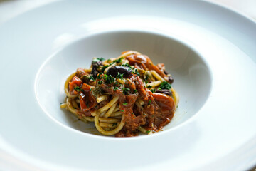 Pasta Puttanesca, Italian traditional spaghetti with capers, olives and anchovies