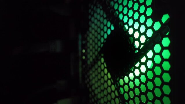 Fan with RGB backlight in a modern powerful computer in the dark. CPU cooling system. 4k loop high quality video. ProRes 422 HQ. Rec 2100 HLG.