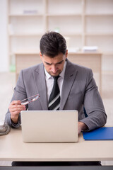 Young male employee working in the office