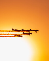 Original name(s): Five plane flying in formation at an airshow at dusk vertical