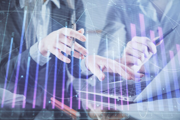 Multi exposure of man and woman working together and financial chart hologram. Business concept. Computer background.