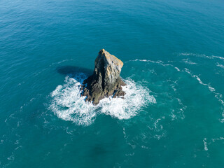 A lone sea stack lies off the Samuel H. Boardman State Scenic Corridor on the southern coast of Oregon. Sea stacks are formed by erosive forces, such as waves crashing, on a headland.