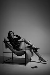 sexy girl with long legs on a chair