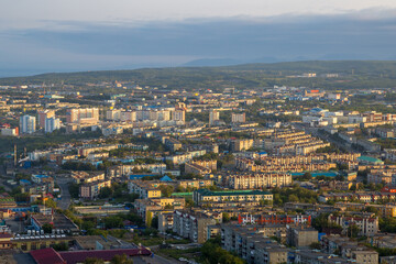 Fototapeta na wymiar Morning cityscape. Top view of the buildings and streets of the city. Residential urban areas at sunrise. Beautiful aerial city landscape. Petropavlovsk-Kamchatsky, Kamchatka Krai, Far East of Russia.