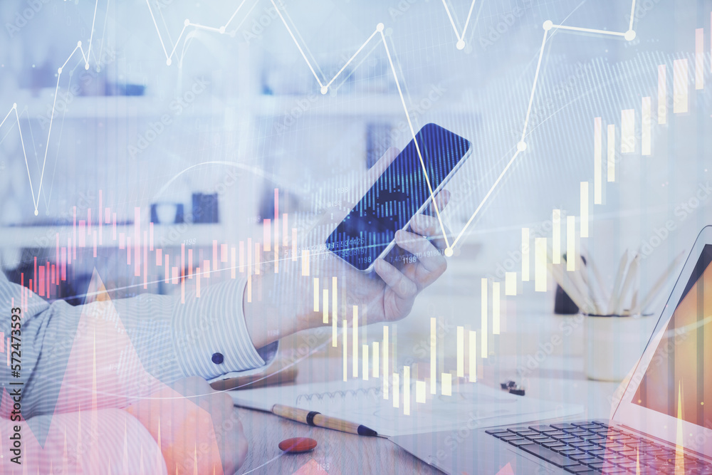 Aufkleber double exposure of man's hands holding and using a digital device and forex graph drawing. financial