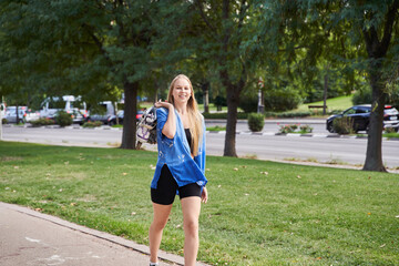 young caucasian sporty woman walking with line skates, ready to practice skating.