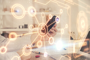 Fototapeta premium Double exposure of man's hands holding and using a phone and social network theme drawing.