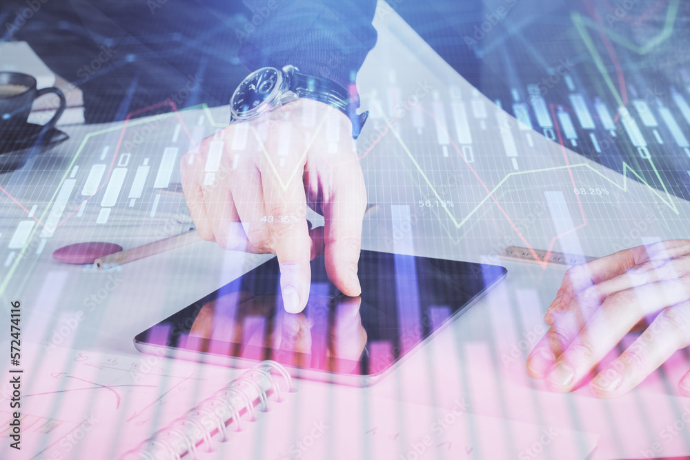 Poster double exposure of man's hands holding and using a digital device and forex graph drawing. financial