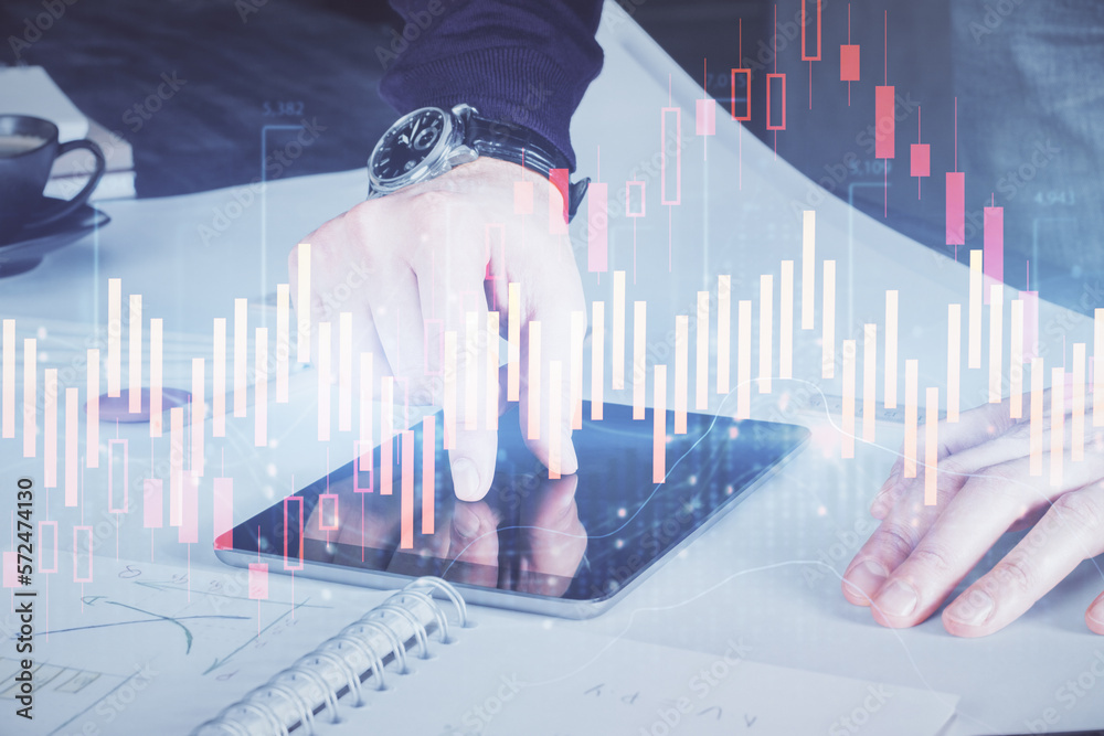 Poster double exposure of man's hands holding and using a digital device and forex graph drawing. financial