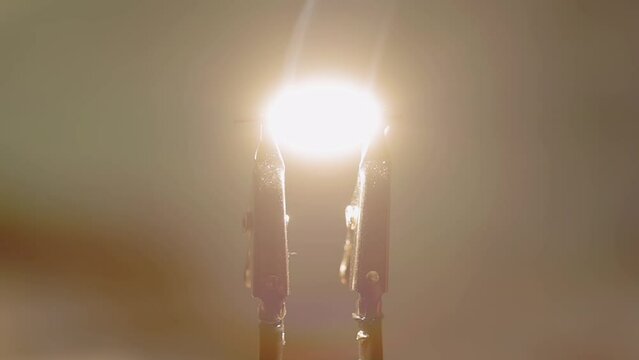 slow motion of the moment a carbon filament light is ignited. This is without the glass bulb so the flame is more pronounced.