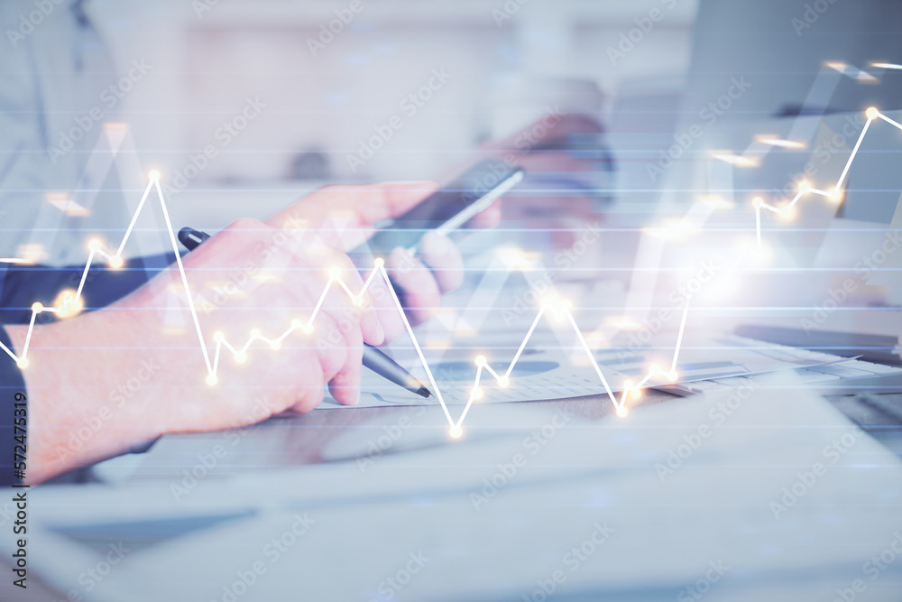 Poster double exposure of man's hands holding and using a phone and financial chart drawing. market analysi