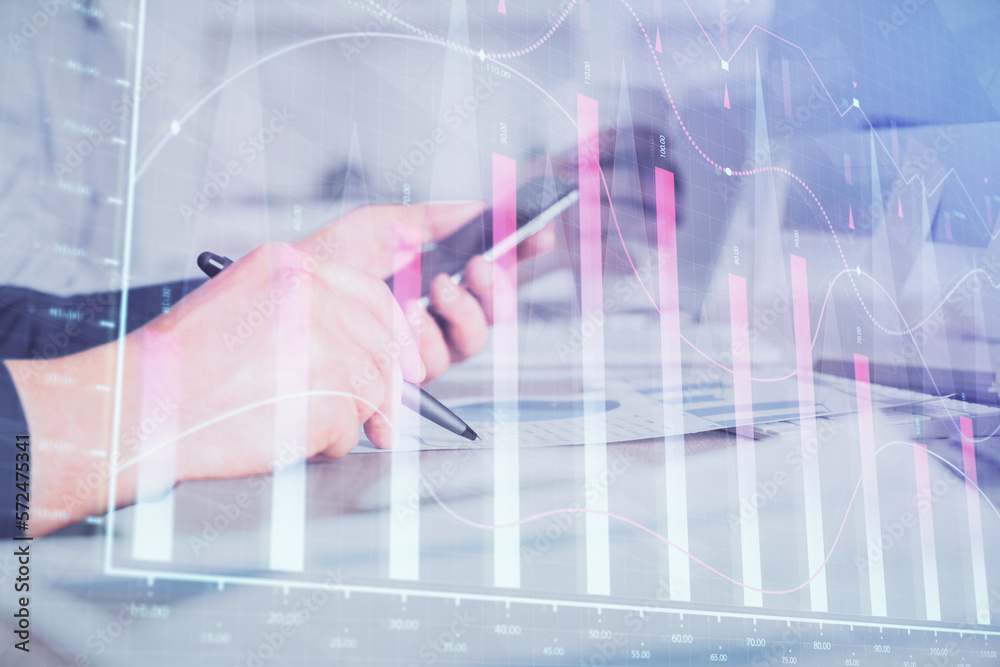 Poster double exposure of man's hands holding and using a phone and financial chart drawing. market analysi