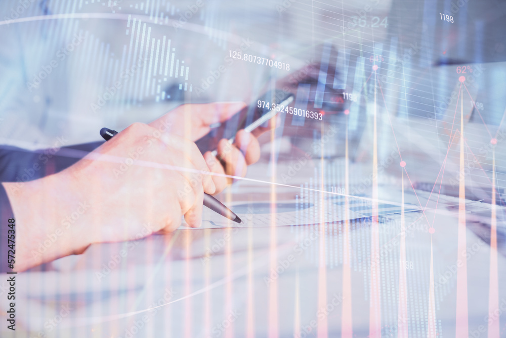 Poster double exposure of man's hands holding and using a phone and financial chart drawing. market analysi