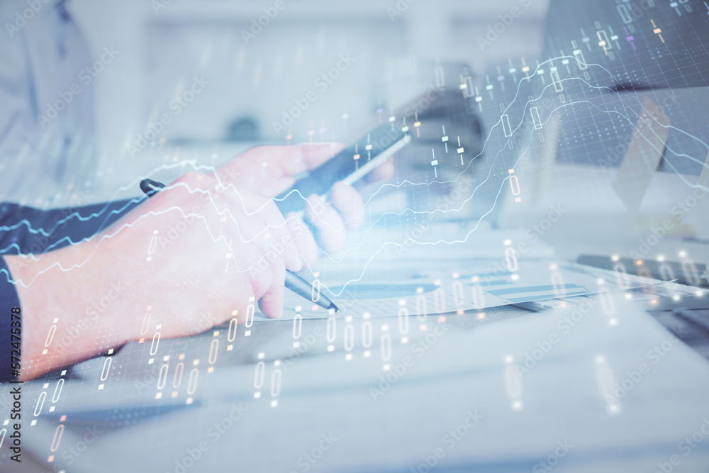 Poster double exposure of man's hands holding and using a phone and financial chart drawing. market analysi