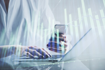 Double exposure of financial graph sketch hologram and woman holding and using a mobile device. Stock exchange concept.
