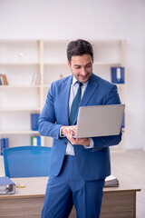 Young male employee working in the office