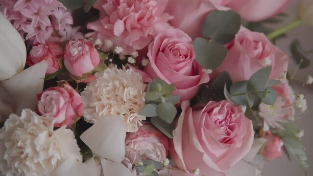 Elegant bouquet of pink roses and other flowers captured in beautiful slow-motion footage. Ideal for a wedding or anniversary celebration.