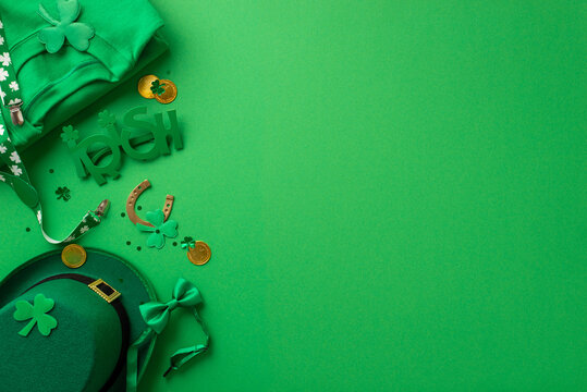 St Patrick's Day concept. Top view photo of green shirt irish party glasses suspenders bow-tie leprechaun hat shamrocks horseshoe gold coins and confetti on isolated green background with copyspace