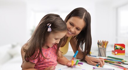 Happy mom helping child to study at home