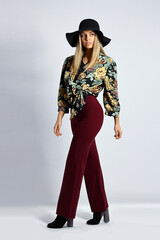 Young woman with hat in studio posing