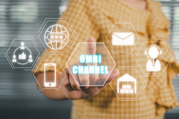 Omnichannel marketing concept, Person hand touching Omnichannel icon on virtual screen, Digital online marketing commerce sale. For customer engagement by integrated online and offline channels.