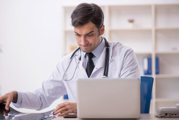 Young male doctor radiologist working in the clinic