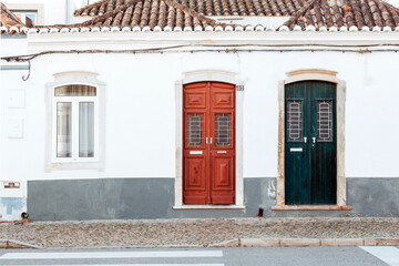 Fototapeta premium Beautiful houses with typical wooden doors in Tavira, Algarve, Southern Portugal.