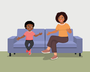 Young African mother talking to her son sitting on sofa giving advises encouragement and support 