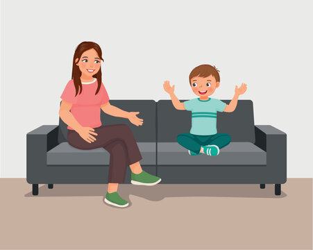 Young mother talking to her son sitting on sofa giving advises encouragement and support 